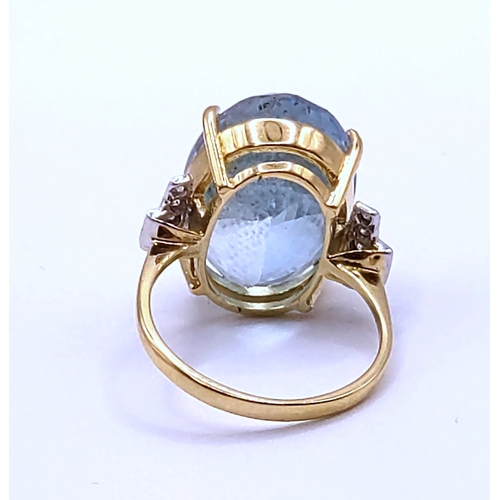 301 - An 18ct yellow gold, diamond, and aquamarine cocktail ring, set with a mixed oval-cut aquamarine of ... 