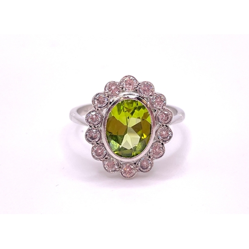 302 - A platinum, diamond, and peridot cluster ring, set with a mixed oval-cut peridot of approximately 1.... 