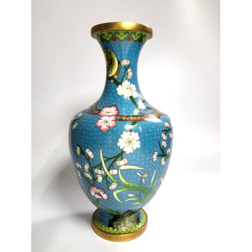 61 - A cloisonne vase with blue ground, bird and blossom, 26cm.