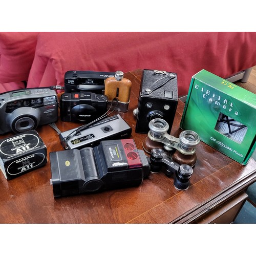 74 - A large collection of vintage cameras, together with binoculars and hip flask.