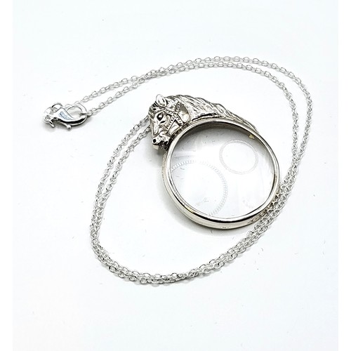 250 - A novelty silver mounted magnifying glass pendant, the round glass surmounted with a horse's head, s... 