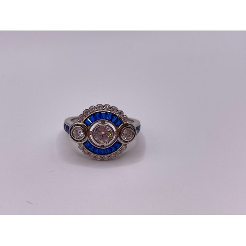 253 - A blue and white cubic zirconia cocktail ring, in the Art Deco style, with collet-set round-cut ston... 