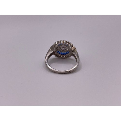 253 - A blue and white cubic zirconia cocktail ring, in the Art Deco style, with collet-set round-cut ston... 