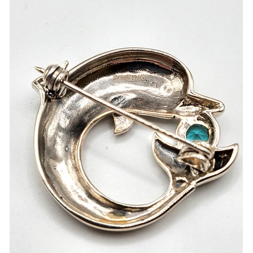 262 - A silver brooch in the form of a dolphin, set with a blue gemstone, marked sterling to reverse, appr... 