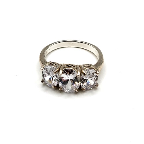 265 - A silver and cubic zirconia ring, set with three oval-cut cubic zirconias, size R 1/2.