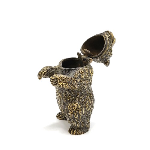 267 - A novelty brass vesta case in the form of a grizzly bear, with red eyes, 6.5 cm high.