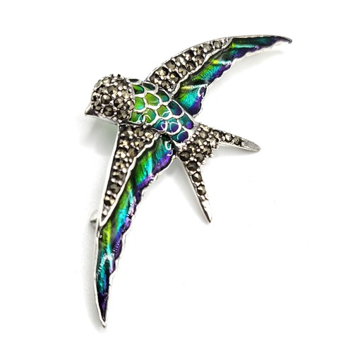 271 - A silver, marcasite, and plique-a-jour style brooch in the form of a bird, 7 cm wide.