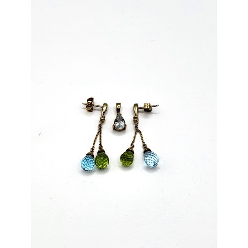 275 - A pair of 9ct yellow gold, topaz, and peridot drop earrings, each suspended with a pear-shaped briol... 