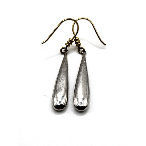 276 - A pair of silver drop earrings, the smooth tapered drops suspended from silver gilt hooks, unmarked,... 