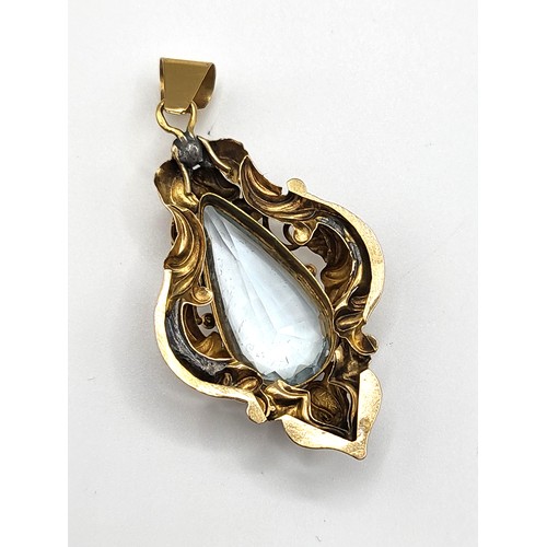 277 - A late Victorian yellow gold and aquamarine pendant, set with a pear-cut aquamarine within an ornate... 