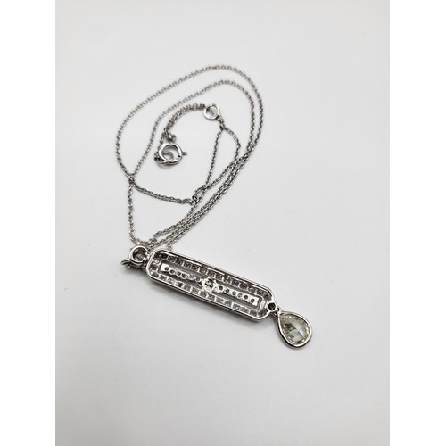 279 - An 18ct white gold and diamond Art Deco pendant, the lozenge-shaped central segment set with round b... 