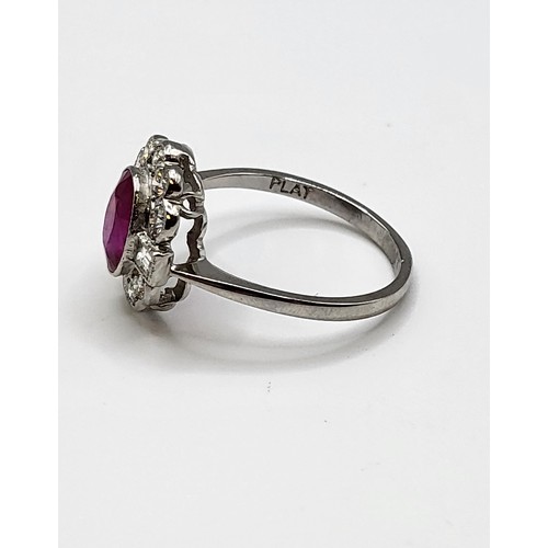 283 - A platinum, diamond, and ruby cocktail ring, set with a mixed oval-cut ruby of approximately 1.65 ca... 