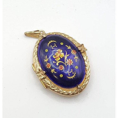 284 - A 9ct yellow gold and enamel locket, decorated with cobalt blue enamel with floral decoration, withi... 