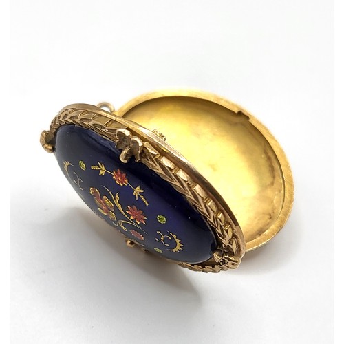 284 - A 9ct yellow gold and enamel locket, decorated with cobalt blue enamel with floral decoration, withi... 