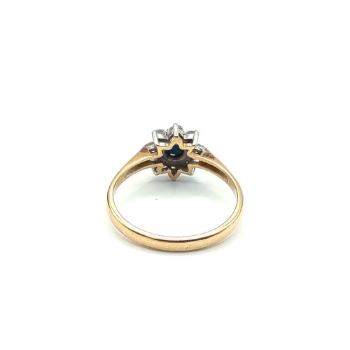 302A - A yellow metal, sapphire, and diamond floral cluster ring, set with a dark blue round-cut sapphire w... 