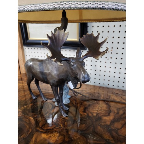 18 - A bronze moose lamp. 57cm including lampshade. (Moose 29cm h)