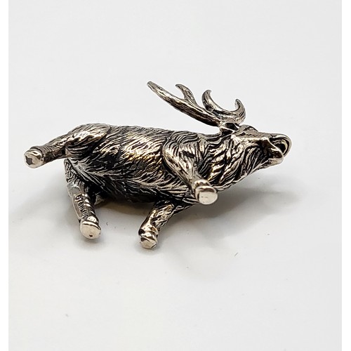 230 - A novelty silver model of a stag, with textured body, marked 'sterling' to leg, 3.7 cm long, 2.8 cm ... 