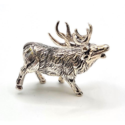 230 - A novelty silver model of a stag, with textured body, marked 'sterling' to leg, 3.7 cm long, 2.8 cm ... 