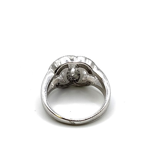 253 - A silver and cubic zirconia cocktail ring, in a designer style, marked 925, size O 1/2.