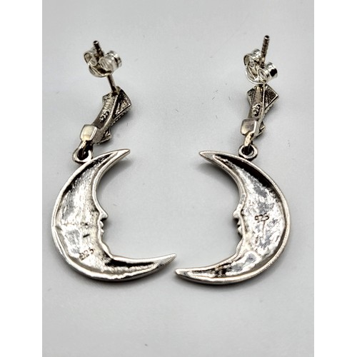 254 - A pair of silver and marcasite drop earrings in the form of a crescent moon, 3.2 cm long.