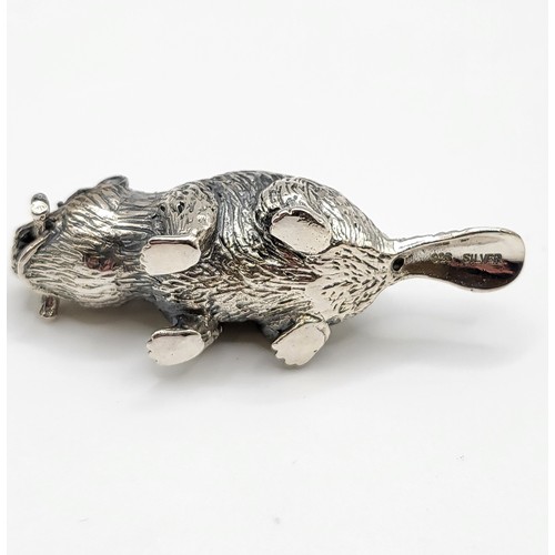 232 - A novelty silver pin cushion in the form of a beaver, with red velvet back, 5 cm long.