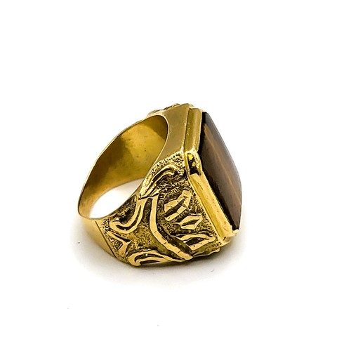 268 - A yellow metal and tigers eye gents ring, set with a smooth tigers eye plaque, the shoulders with st... 