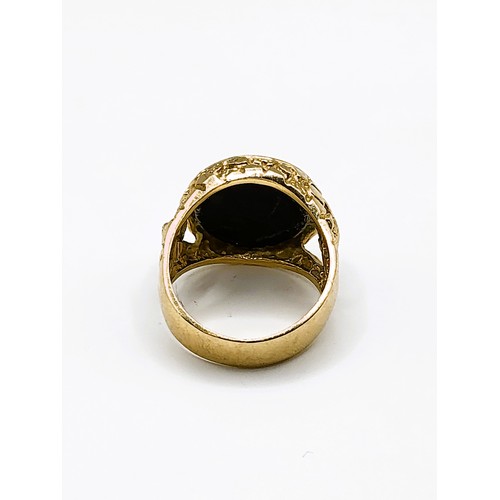 275 - A yellow gold, tigers eye and onyx ring, set with three angular segments of onyx and tigers eye, the... 