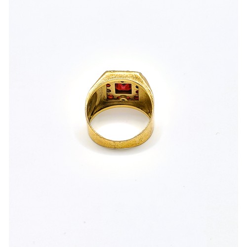 282 - A yellow metal and garnet gents ring, set with a square cluster of mixed rose-cut and faceted garnet... 