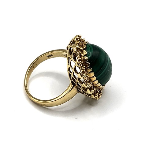 295 - A yellow gold and malachite ring, set with an oval cabochon malachite, measuring approximately 16 x ... 