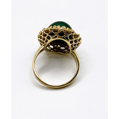 295 - A yellow gold and malachite ring, set with an oval cabochon malachite, measuring approximately 16 x ... 