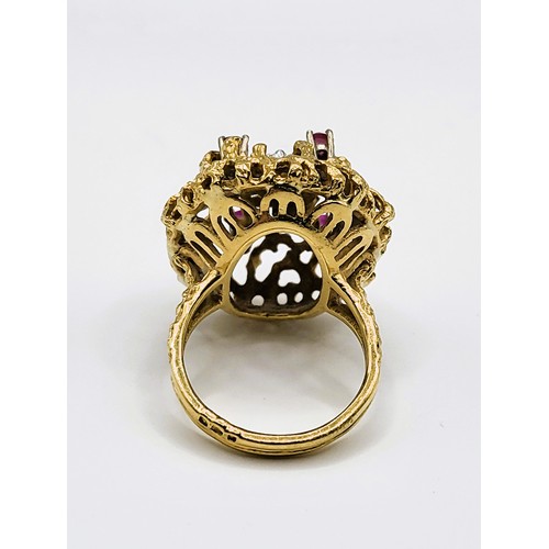 296 - An unusual mid to late 20th century yellow gold, diamond, and ruby cocktail ring, the textured natur... 