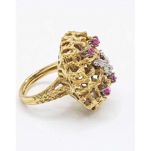 296 - An unusual mid to late 20th century yellow gold, diamond, and ruby cocktail ring, the textured natur... 