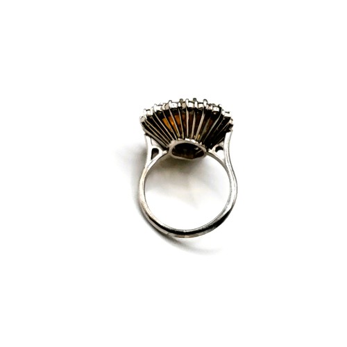 304 - An 18ct white gold, diamond, and citrine cocktail ring, set with a pear-cut citrine measuring approx... 