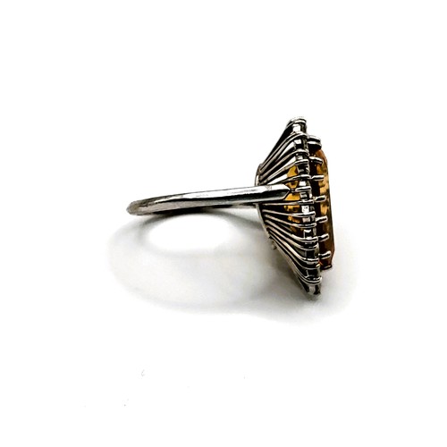 304 - An 18ct white gold, diamond, and citrine cocktail ring, set with a pear-cut citrine measuring approx... 