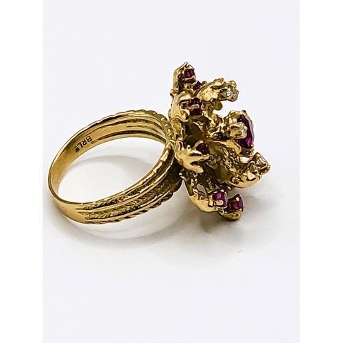 305 - An 18ct yellow gold, diamond, and ruby cocktail ring, set with a rounded cushion-cut ruby measuring ... 