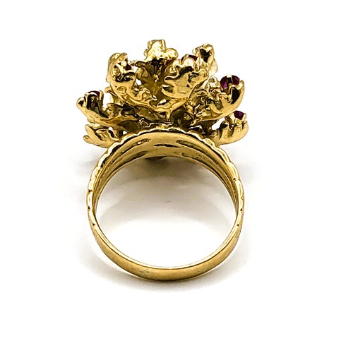 305 - An 18ct yellow gold, diamond, and ruby cocktail ring, set with a rounded cushion-cut ruby measuring ... 