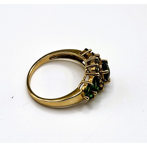 311 - A 9ct yellow gold and green gemstone ring, set with an oval cluster of green quartz gemstones, the s... 