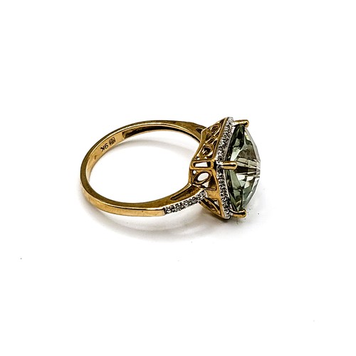 312 - A 9ct yellow gold and prasiolite ring, set with a chequerboard faceted green quartz, surrounded with... 