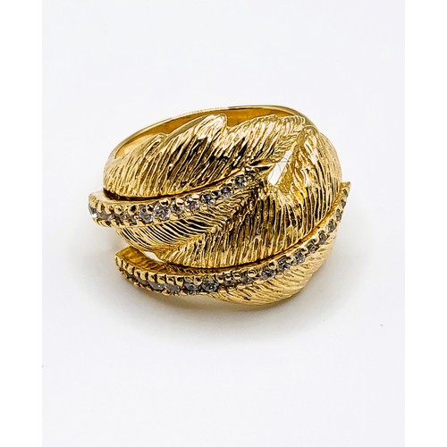 313 - A silver gilt and cubic zirconia double feather design cocktail ring, together with a matching pair ... 