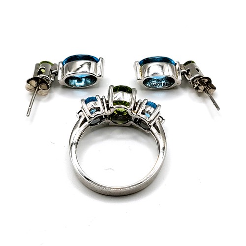 316 - A 14ct white gold, peridot, and blue topaz ring, interspersed with diamond accents, size Q, together... 