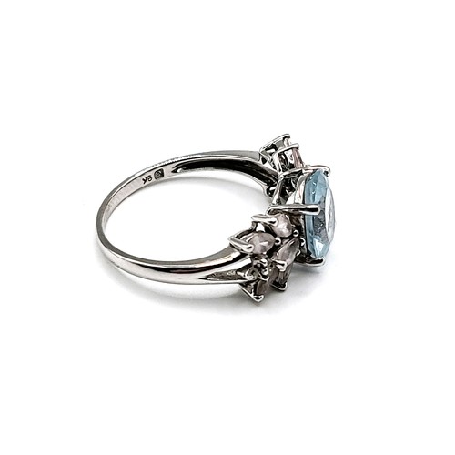 319 - A 9ct white gold, pale blue topaz, and rose quartz ring, set with a mixed oval-cut topaz, with marqu... 