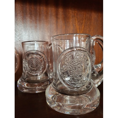 175 - A group of Dartington glass mugs, various dates.