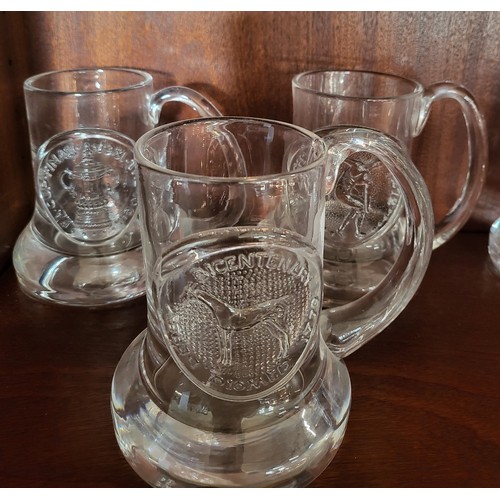 175 - A group of Dartington glass mugs, various dates.