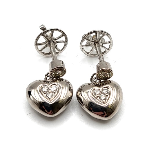 329 - A pair of 18ct white gold and diamond heart earrings,  marked 18ct and 750.