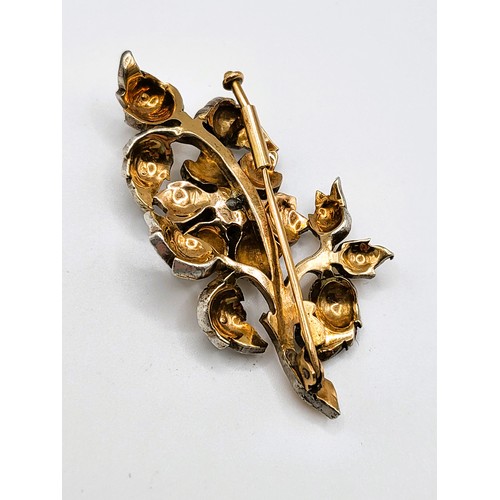 333 - A mid 20th century vintage gold and diamond brooch, of foliate design, centred with a round-cut diam... 