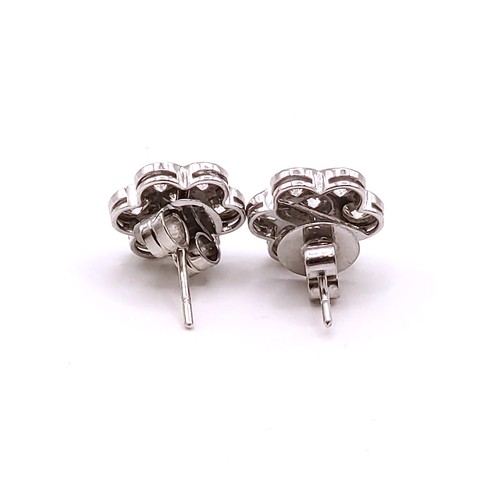 345 - A pair of 18ct white gold and diamond floral cluster ear studs, the round brilliant-cut diamonds of ... 