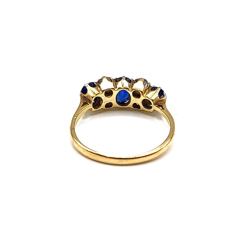 354 - An 18ct yellow gold, diamond, and sapphire ring, set with three mixed oval-cut sapphires, and four o... 