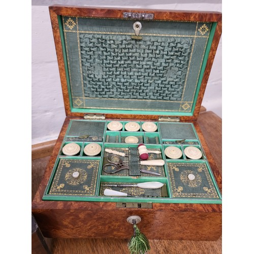 97 - A late 19th / early 20th century green lined sewing box, containing various sewing paraphernalia, to... 