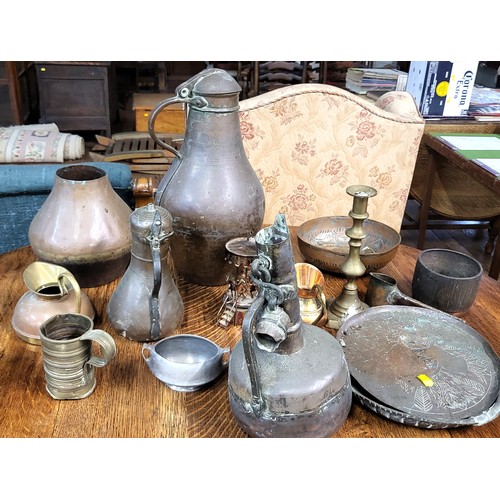 100 - A collection of various brassware including pots, jugs, bowls, a candlestick, etc.