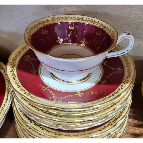 199 - T. Goode & Co. tea-wares with claret and gilt band decoration. (Jug with hair-line crack and chips) ... 